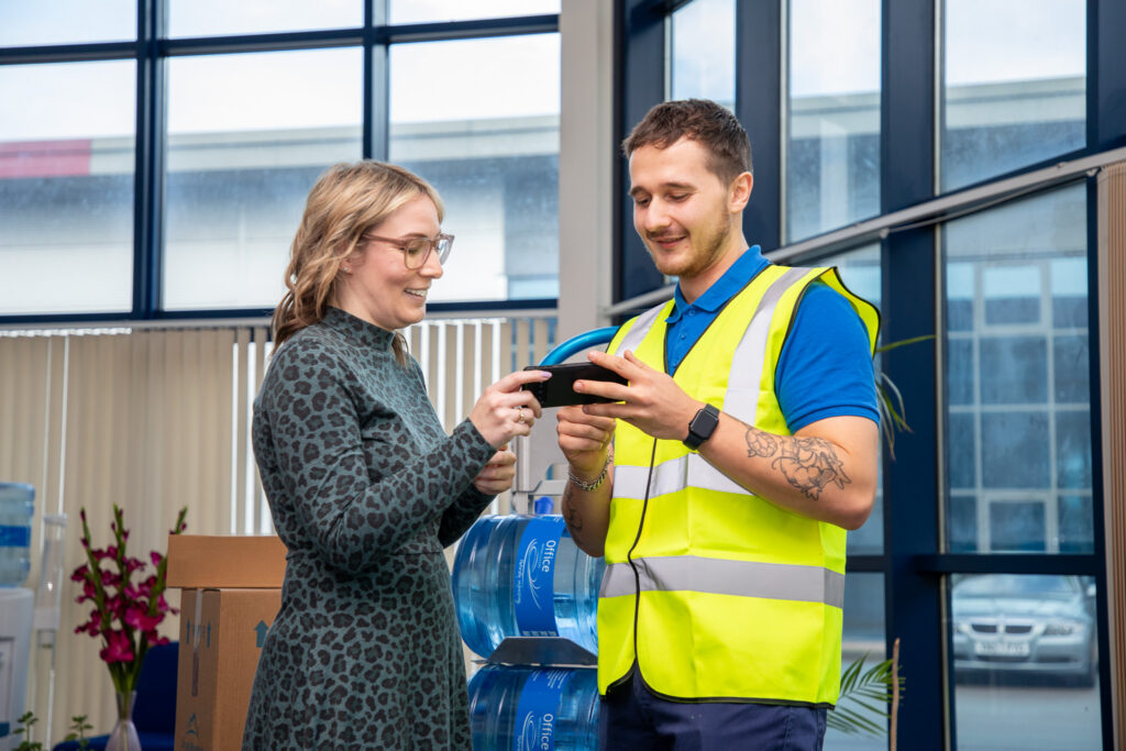 Engineer helping customer with an query whilst delivering products