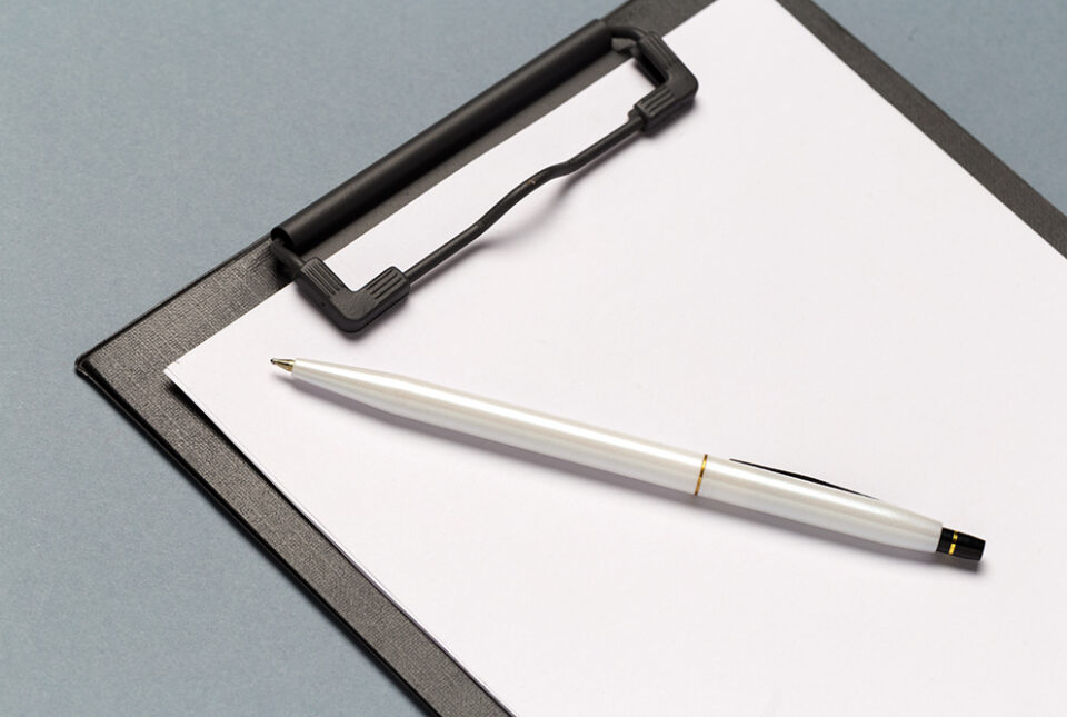 Notes clipboard with pen and blank sheets of paper